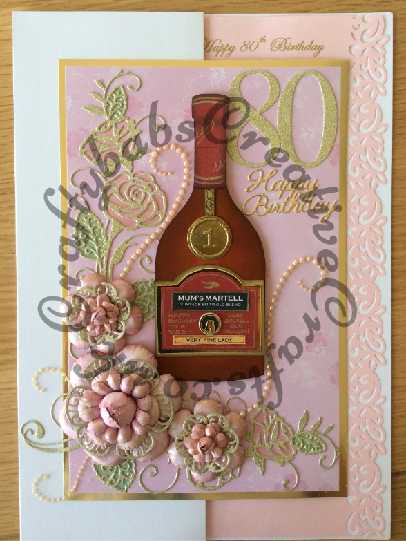 A4 size 80th Birthday card for a special Mum. Made using custom made bottle die, Tattered Lace Lavish Blooms Poppy and Majestic Rose dies, Quickutz Cookie cutter number dies & Britannia sentiment dies, plus various labels & circle dies and embossing folder for bottle seal and labels - craftybabscreativecrafts.co.uk