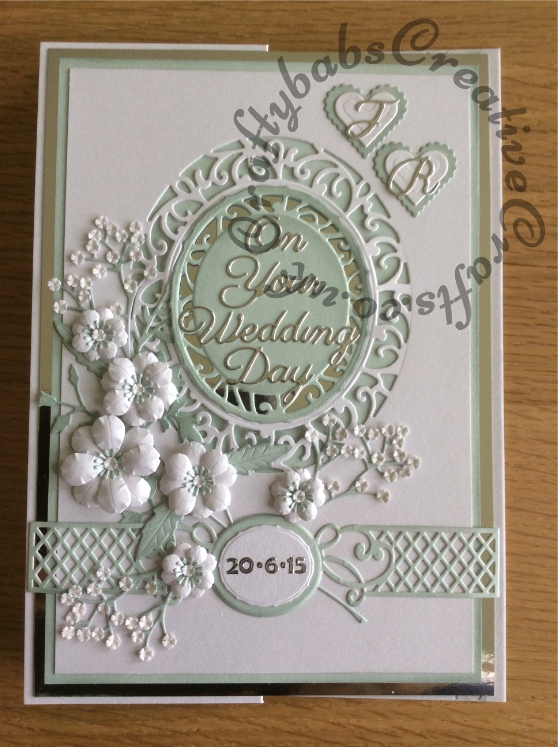 Wedding card made using a variety of dies including Tonic ovals, spellbinders nesting plain & scalloped hearts, Memory box flowers and leaves, Cheery Lynn baby's breath, Britannia sentiment and alphabet dies, Spellbinders romantic agenda heart and swirls decorative strip dies - craftybabscreativecrafts.co.uk