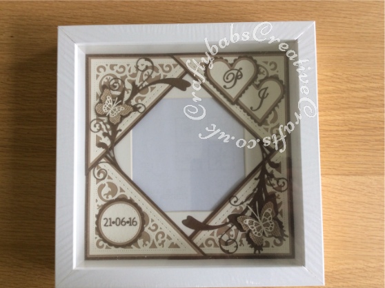 Wedding card and matching photo frame gift made to match wedding invitation using a variety of dies including; Spellbinders gold elements one dies, Labels 25 and majestic labels 25, and Nesting plain and scalloped hearts dies, Memory Box Gwyneth flourish and Levenworth and Cascadia butterfly trio dies, Cheery Lynn delicate lace script dies, Britannia sentiment die,Tattered Lace 'A Date To Remember' dies, Quickutz Nesting plain and scalloped circle dies. and spellbinders les papillions die. Hessian butterflies were shop bought. Hessian ribbon, string & wooden heart were on wedding invitation, rub on transfers applied to both sides of wooden heart - craftybabscreativecrafts.co.uk