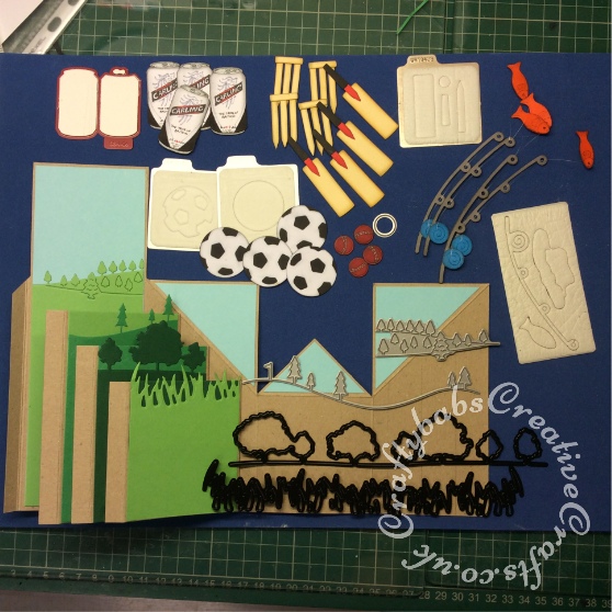 Cricket, Fishing, Football Men Pop Up Card made using a variety of dies including; Quickutz cookie cutter soda can and nesting circles (smallest one for cricket ball) die, 2x2 single cutz cricket die, 2x2 double cutz football die, Go Kreate boo bear fishing die, Xcut scene grass and trees border dies, Memory box golf landscape die and Tattered Lace panorama trees die - craftybabscreativecrafts.co.uk
