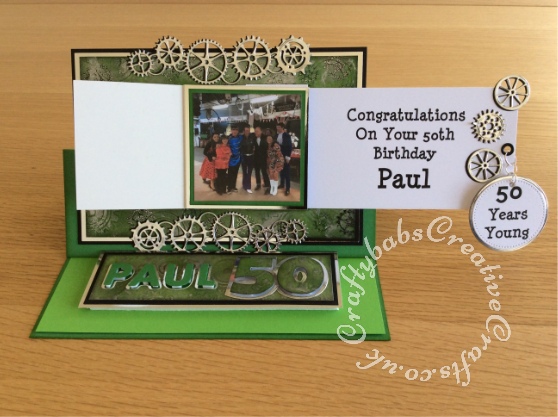 Men's Waterfall easel birthday card made using Memory Box gearworks border die, Nesting circles dies, Sizzix originals shadow box numbers dies and Sizzix Sizzlits Fruit Smoothie alphabet dies, Background embossed with cogs and gears embossing folder and gilded with silver gilding wax, and stamped - craftybabscreativecrafts.co.uk