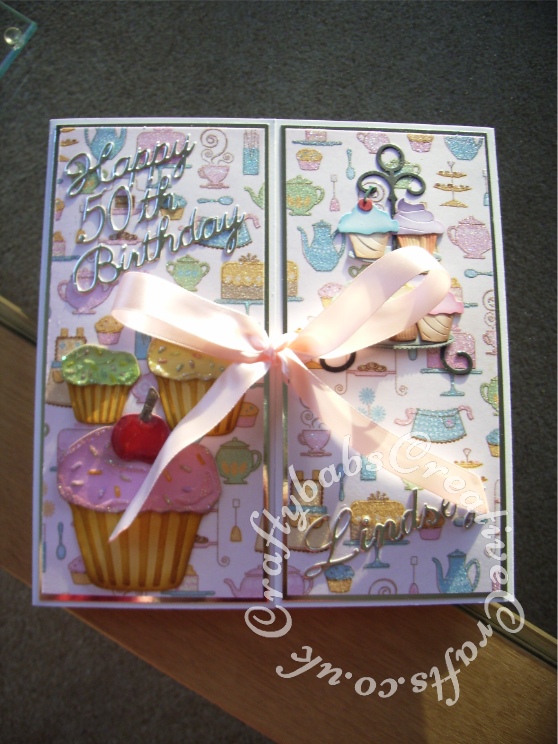 Gate Fold large double shutter birthday card made using a variety of dies including; Cottage Cutz cupcake tier 4x4 die, Spellbinders shapeabilities cupcake dies, Britannia Dies Happy Birthday sentiment, Cheery Lynn Delicate Lace Script Alphabet dies, Ellison thin Apron die, Ellison thin rolling pin die, Ellison thin chef's hat die, Ellison thin oven mit die, Ellison thin measuring spoons die Memory Box Pippi & Isabella butterfly dies, Memory Box Kaleidoscope and Moonlight butterfy dies. - craftybabscreativecrafts.co.uk