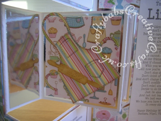 Gate Fold large double shutter birthday card made using a variety of dies including; Cottage Cutz cupcake tier 4x4 die, Spellbinders shapeabilities cupcake dies, Britannia Dies Happy Birthday sentiment, Cheery Lynn Delicate Lace Script Alphabet dies, Ellison thin Apron die, Ellison thin rolling pin die, Ellison thin chef's hat die, Ellison thin oven mit die, Ellison thin measuring spoons die Memory Box Pippi & Isabella butterfly dies, Memory Box Kaleidoscope and Moonlight butterfy dies. - craftybabscreativecrafts.co.uk