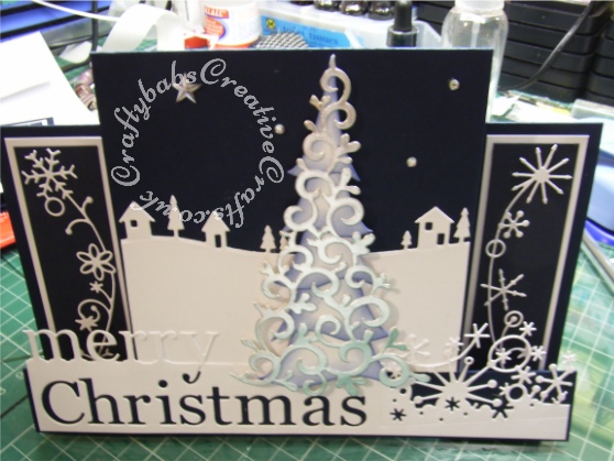 Scenic Stepper Christmas card made using Memory Box Grand merry Christmas die, Memory Box country landscape die, Memory Box snowy breeze border die, Memory Box Frostyville border die, Dee's Distinctively Christmas tree overlay #1 die and Dee's Distinctively Christmas tree stacker die - craftybabscreativecrafts.co.uk