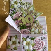 Pop Up Box 30th Birthday card made to co-ordinate with invitation, using a variety of dies including Altenew rose stamp & die set free in issue 149 of Simply Cards & Papercraft, Altenew Christmas rose stamp & die set free with issue 57 of Simply Cards & Papercraft, Sizzix 'Girls Are Wierd' Sizzlits alphabet dies, Sizzix Framelits stars Primitive die set, Sizzix Originals Shadow Box Numbers dies, Sizzix Thinlits Tim Holtz Celebration Words - Script dies and floral sprig dies from The Works. Card use for Matting and layering was printed with background from KanBan Female background papers CD Rom. Nail Caviar applied to centres of Christmas rose flowers and all flowers embossed with ball tools to add dimension. - craftybabscreativecrafts.co.uk