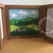 Golf themed Shadow Box Window Card made using a number of dies including; Tonic shadow Box Creations Die set 1635E, Tattered Lace sentiments dies, Lea'bilities Golf Bag & Clubs dies, Spellbinders golf die for flag and gold ball, Memory Box Dies, Mini Golf Carts, Memory Box Golf cart, Memory Box Golf landscape die, Clouds from Xcut Build a scene All aboard die set, Grass border from Xcut English Countryside Borders die set and Tattered Lace Panorama Trees (D634), The base card is plain brown which I have inked with distress inks in various shades of brown through a wood grain effect stencil. - craftybabscreativecrafts.co.uk