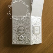 Pop up Silver Wedding Anniversary card made using a number of dies including; Spellbinders nesting plain and scalloped hearts dies, Cheery lynn flowers dies, Anna griffin flourish scroll die, spellbinders lacey circles dies, Crea Nest lies no 33 dies, leabilities frame square curve die set (for small flourishes). Joy cut & emboss wedding die set, Nellies nesting stitched squares dies, Background embossed with distress ink applied to folder using embossaliscious a4 folder. die cuts inked whilst in die in matching distress ink (Hickory Smoke). - craftybabscreativecrafts.co.uk
