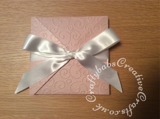 Baby Girl Birth keepsake made using a variety of dies including Quickutz nesting Tag dies, Ellison thick cutz envelope die, Cuttlebug baby elements die, Marianne baby feet dies, Memory Box pram die, nesting plain & scalloped oval dies, Memory box alphabet soup upper and lower case dies, Parchment pocket made using an envelope template stencil, baby clothes and baby words embossed using brass stencils, outer cover embossed using couture creations intrinsic embossing folder - craftybabscreativecrafts.co.uk