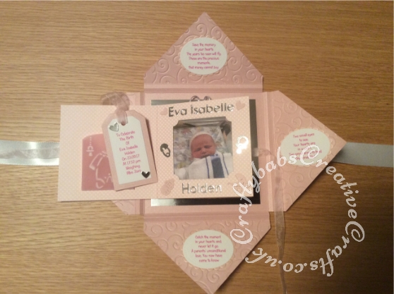 Baby Girl Birth keepsake made using a variety of dies including Quickutz nesting Tag dies, Ellison thick cutz envelope die, Cuttlebug baby elements die, Marianne baby feet dies, Memory Box pram die, nesting plain & scalloped oval dies, Memory box alphabet soup upper and lower case dies, Parchment pocket made using an envelope template stencil, baby clothes and baby words embossed using brass stencils, outer cover embossed using couture creations intrinsic embossing folder - craftybabscreativecrafts.co.uk