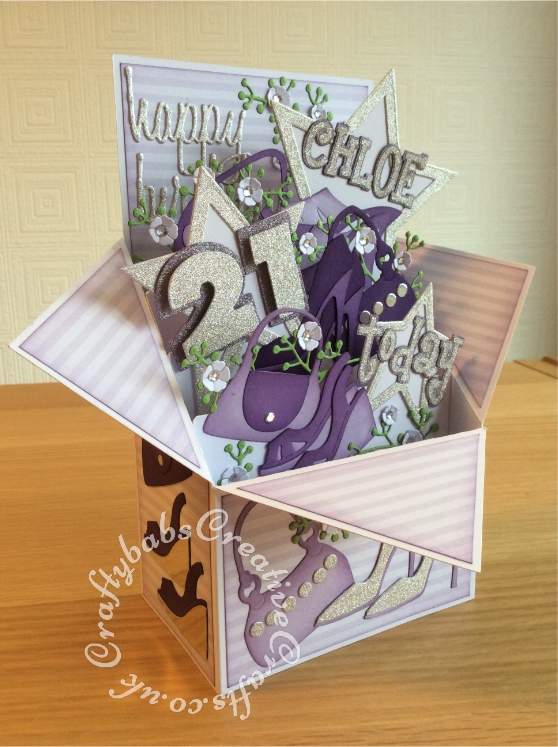 Large Pop Up Shoes & Bags themed 21st Birthday card made from 8"x8" card blank. Numerous dies used including; Sizzix Framelits Stars/ Primitive Die Set, Sizzix sizzlits 'Girls Are Weird' alphabet dies, Sizzix originals Shadow Box numbers, Sizzix sizzlits small purses and shoes set and shoes set, Ellison window cuts handbag, Cheery Lynn Baby's breath flower set, MCS sprig dies (from The Works) and Sentiment die cut using 660223 Sizzix Thinlits Die Set 13PK - Celebration Words Script by Tim Holtz - craftybabscreativecrafts.co.uk