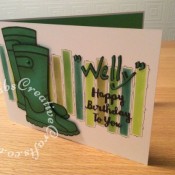Wellington Boots Birthday card made using Sizzix Sizzlits Catty Corner alphabet dies, sentiment dies free with a crafting magazine. Background dry embossed and inked through a stencil and highlighted with microfine pen. Wellinton boots stamped onto green card using Woodware Clear Magic Wellies stamp FRS208 and shaded with peeled paint distress ink - craftybabscreativecrafts.co.uk