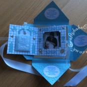 Baby Boy Birth keepsake made using a variety of dies including Quickutz nesting Tag dies, Ellison thick cutz envelope die, Cuttlebug baby elements die, Marianne baby feet dies, Memory Box pram die, nesting plain & scalloped oval dies, Memory box alphabet soup upper and lower case dies, Parchment pocket made using an envelope template stencil, baby clothes and baby words embossed using brass stencils, outer cover embossed using couture creations intrinsic embossing folder.- craftybabscreativecrafts.co.uk