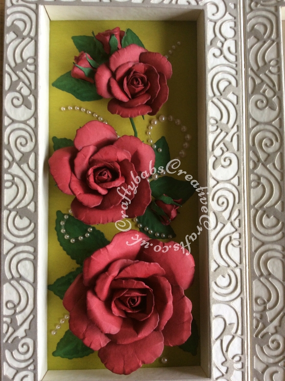 Shadow Box framed Roses 75th Birthday card made using the Tonic shadow Box Creations Die set 1635E and co-ordinating Tonic Family Three Shadowbox Insert Die (frame only) Set to make base card from 2 shadow boxes. Roses inside shadow box made using Spellbinders Rose Creations die set and tinted with distress ink. Rose embellishment on front of card made using the Free Gift rose dies from DIE-CUTTING-ESSENTIALS-MAGAZINE-ISSUE-19. Sentiments cut using Tattered Lace Sentiment dies and die'sire numbers dies - craftybabscreativecrafts.co.uk