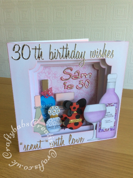 Large 8"x 8" Perfume themed Panorama 30th Birthday Card made using Various dies including; Various Sizzix Tim Holtz thinlits 'Script@ words, Sizzix Sizzlits 'Catty Corner' alphabet dies, Numbers from the Sizzix - Tim Holtz - Alterations Collection - Thinlits Die - Alphanumeric, Script alphabet dies, Wine bottle Die from Die Cutting Essentials Magazine Issue 28 and base of glass from same set, top of glass made using Tattered Lace Essentials Teardrop Cutting Dies ETL183 trimmed to shape. Perfume bottles made using various dies including circles, tear drops and trimmed to shape, Base card made using Tattered Lace Large panorama dies partially cut then extended to fit 8"x 8" card, apertures cut using Tattered Lace Essentials notched Squares dies. - craftybabscreativecrafts.co.uk