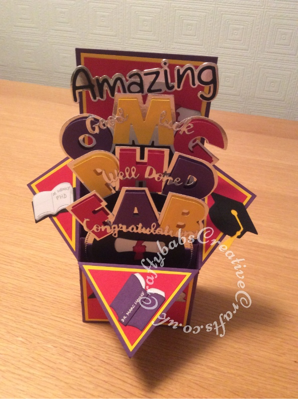 Pop Up Box PHD Graduation card made using a variety of dies including; Sizzix Shadowbox Alphabet dies, Sentiment dies free with issue 109 of Papercrafter magazine, Crafti Potential 'Amazing' sentiment dies, and various Quickutz 2" dies. - craftybabscreativecrafts.co.uk