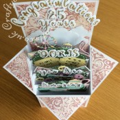 Pop up Box Congratulations card made using various dies including; Nellie's Multi Frames Dies Doily Flower MFD020, Crafters Companion Gemini Expressions Metal Die - Uppercase and lower case Alphabet and number Sets, scenic dies free gift from issue 39 of Die Cutting Essentials magazine, SIZZIX SIZZLITS TEATIME Set 654787, HELZ CUPPLEDITCH DIE - FUN FAIR - TICKET dies, cloud dies from various Xcut build a scene All Aboard die set. Mats and layers on base card embossed with Embossalicious A4 embossing folder, then pearl fininsh addes using Cosmic Shimmer gilding polish accented with Cosmic Shimmer Glitter Kiss. Bingo cards and numbers stamped and embossed using La Pashe flippin bingo stamp set. - craftybabscreativecrafts.co.uk