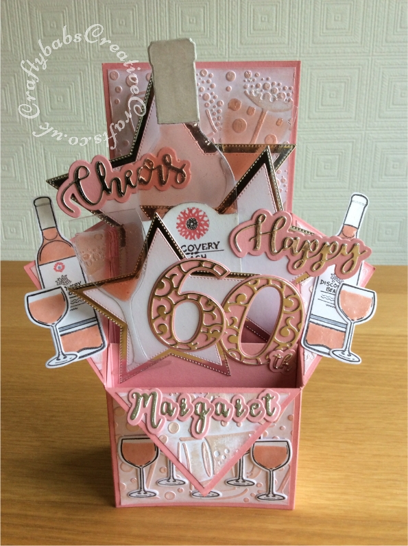 Wine Themed 60th Birthday Pop Up Box card made using a vriety of dies including; CARD MAKING MAGIC DIE SETS SOLID & OVERLAY NUMBER & SUFFIX, Unbranded nesting stitched stars dies, i Craft Cheers & Happy dies, Apple Blossom Die Set Cheers! Wine Bottles & Glass, Apple blossom dies, embossing folder and stamps from Issue 161 of Simply cards & Papercraft magazine and Crafters companion Gemini Expressions Metal Die – Uppercase and lower case Alphabet Sets. - craftybabscreativecrafts.co.uk