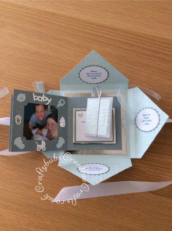 Baby Boy Birth keepsake made using a variety of dies including Marianne Design Cutting and embossing stencils Creatables - My first sneakers, Quickutz nesting Tag dies, Lettering created using Memory box Alphabet soup upper case and lower case alphabet dies, Ellison thick cutz envelope die, Cuttlebug baby elements die, Marianne baby feet dies, Spellbinders nesting plain & scalloped oval dies, Parchment pocket made using an envelope template stencil, baby clothes and baby words embossed using brass stencils, outer cover embossed using Crafter's Companion Basket Weave - Texture 8x8 Embossing Folder. - craftybabscreativecrafts.co.uk