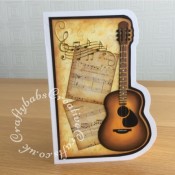 Guitar music themed card made using the contents of the Papercraft Society Box June 2020 Olga Direktorenko - plus - distress inks, black card stock, white card stock and nylon thread. - craftybabscreativecrafts.co.uk