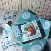Baby Boy Birth keepsake made using a variety of dies including: Tattered Lace Essentials Die - Notched Squares ETL311, Quickutz nesting Tag dies, Lettering created using Memory box Alphabet soup upper case and lower case alphabet dies, Ellison thick cutz envelope die, Cuttlebug baby elements die, Marianne baby feet dies, Spellbinders nesting plain & scalloped oval dies, Parchment pocket made using an envelope template stencil, baby clothes and baby words embossed using brass stencils, outer cover embossed using score board. - craftybabscreativecrafts.co.uk