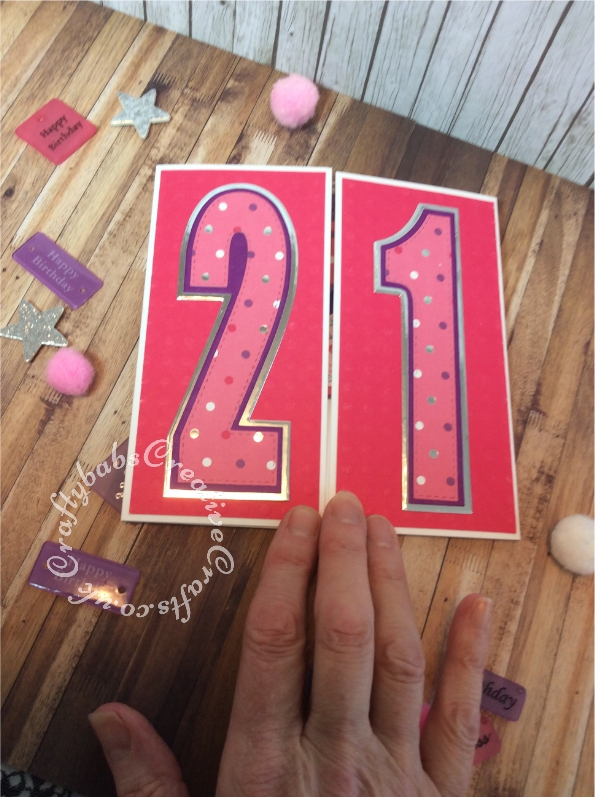 Pop up 21st birthday card inspired by Sam Calcott of Mixed Up Crafts. I didn't have the Made to Surprise dies to make this but managed to make my own mechanism using a scoreboard and craft knife. I used a old pack of chip board embellishments that has been in my stash for years, they came with coordinating papers too. I die cut the numbers using unbranded layered numbers dies. - craftybabscreativecrafts.co.uk
