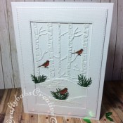White on white layered Christmas card made using various dies including: unbranded stitched rectangle dies, unbranded bare trees die, foliage dies and Mini Three Little Birds die by Tattered Lace. - craftybabscreativecrafts.co.uk