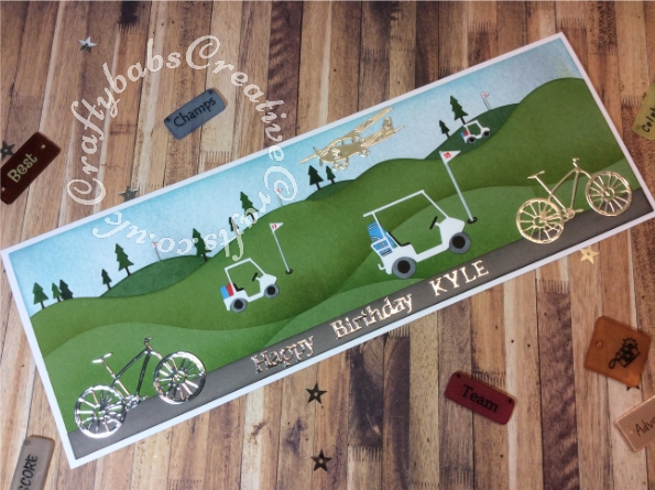Golf and cycling themed card made using various dies including; Memory Box Dies, Mini Golf Carts, Memory Box Golf cart, Memory Box Golf landscape die, Tattered Lace Hat and Cane embellishments set for the aeroplane and Tattered Lace sentiments 2014 dies. Cycle from the Hunkydory Moonstone Build a shed die set. - craftybabscreativecrafts.co.uk