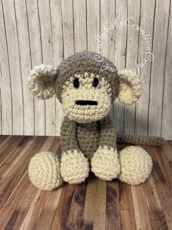 Mace the Monkey, made for my Grandson using a kit by Hoooked. The yarn quality is really goo and instructions are not too bad though a little prior experience is helpful, I found the instructions for the ears a little confusing but managed in the end. This was quite tough on the hands to make but the end result is good and strong and should withstand years of loving and hugging from the most enthusiastic of monkey keepers. - craftybabscreativecrafts.co.uk