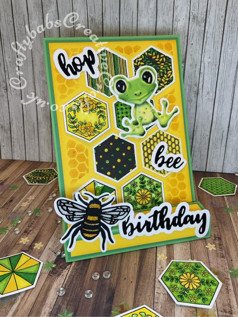 Pop up Easel Block Birthday Card. Fold inspired by Sam Calcott of Mixed up craft. Made using various dies including Sizzix Thinlits Die Set 4 Pack 663852, Bee by Lisa Jones, stamps free with issue 109 of Creative Stamping Magazine, Tattered Lace Freda Frog die and download, Bright Rosa Sentiment dies snipped to create the words 'hop' and 'bee' and nesting hexagon dies. - craftybabscreativecrafts.co.uk