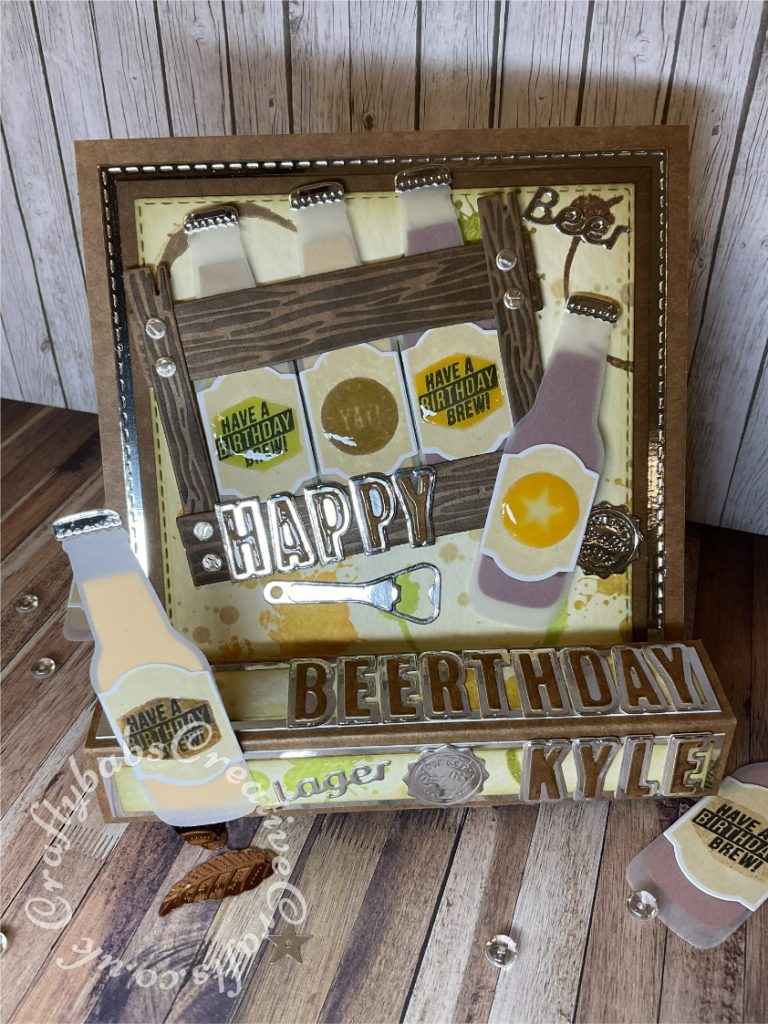 Pop up Easel Block Birthday Card. Fold inspired by Sam Calcott of Mixed up craft. Made using various dies and stamps including:- Stampin Up 'Bubble Over' stamp and dies set. Apple blossom drinks trolley beer bottle and glass die set for bottle opener, Unbranded layered alphabet dies, and CR1348 ~ WOOD ~ Marianne Design Craftables Die. - craftybabscreativecrafts.co.uk