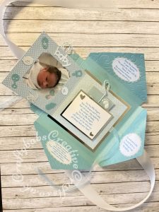 Baby Boy Birth keepsake made using a variety of dies including Tattered Lace Essentials nesting Notched squares dies, Marianne Design Collectables Cutting Dies - Eline's Babies Col1479, Marianne designs Creatables baby feet dies, MEMORY BOX 98867 "Baby Bottles" die, Memory box Baby clothes die 98625, Memory Box Pram Die, Memory Box Alphabet soup Upper case and lower case alphabet dies, Quickutz nesting Tag dies, Ellison thick cutz envelope die, Spellbinders nesting plain & scalloped oval dies, Parchment pocket made using an envelope template stencil, baby clothes and baby words embossed using brass stencils, outer cover embossed using couture creations intrinsic embossing folder. - craftybabscreativecrafts.co.uk